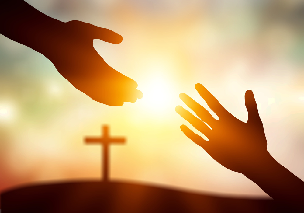 World Peace Day Concept:Silhouette of Jesus Reaching Out Hand